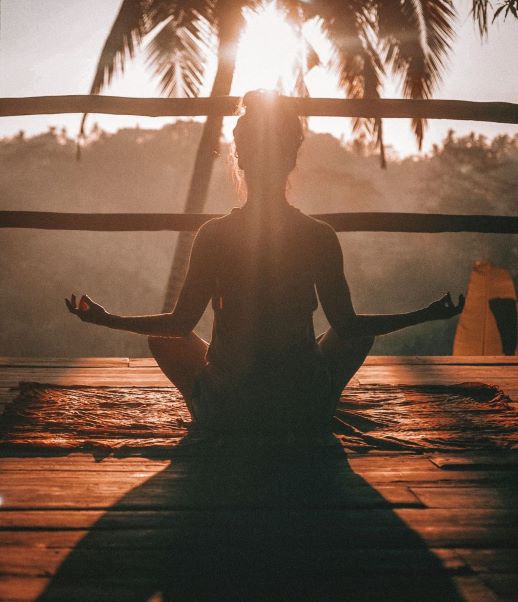 silhouette of a woman meditating